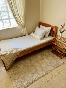 a bed in a room with a window at Casa Solenda in Ruaka +25 photos