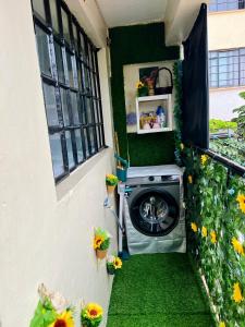 a washing machine in a house with a window at Casa Solenda in Ruaka