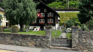 a house with a gate and a stone wall at Chalet Piumogna in Faido +27 photos