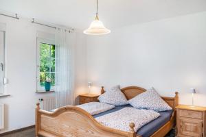 a bedroom with a wooden bed and a window at Ferienhaus Schenum in Jever