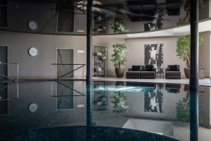 a living room with a swimming pool in a building at Hotel Patrizia in Tirolo