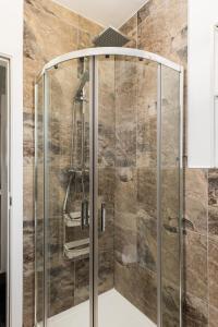 a shower with a glass door in a bathroom at Executive Harborne House in Birmingham +33 photos