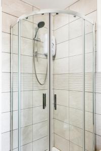 a shower with a shower head in a bathroom at Executive Harborne House in Birmingham