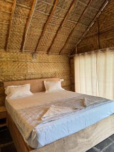 a bedroom with a large bed in a building at Dream Mango Hampi in Hampi