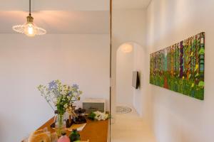 a hallway with a table and a painting on the wall at 월영사계 in Seogwipo