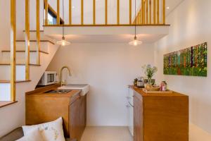 a small kitchen with a sink and a staircase at 월영사계 in Seogwipo +12 photos