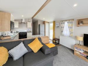 a living room with a couch and a kitchen at Sandy Paws - Uk45511 in Mainsriddle