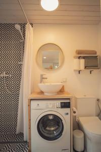 a bathroom with a washing machine and a sink at Hygge House Hiiumaa in Hiiumaa