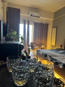 a group of glasses sitting on a table in a room at The sliversapling stay in Greater Noida