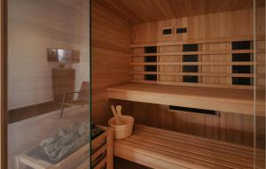 a sauna with wooden walls and wooden flooring at Gorgeous Home In Momjan With Sauna in Momjan +32 photos