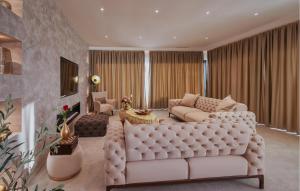 a living room with a white couch and a table at Gorgeous Home In Momjan With Sauna in Momjan