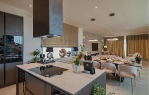 a kitchen and dining room with a table and chairs at Gorgeous Home In Momjan With Sauna in Momjan