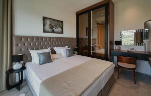 a bedroom with a large bed and a desk at Gorgeous Home In Momjan With Sauna in Momjan