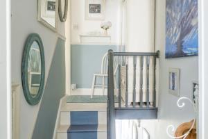 a staircase in a home with blue and white walls at Almond Cottage - Pets welcome - Free Parking - Garden in Hayle +31 photos