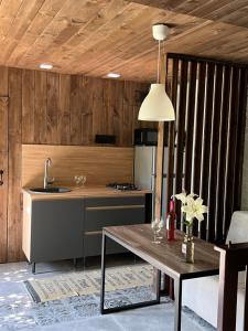 a kitchen with a table and a sink and a counter at ДЗЕН Garden in Fontanka