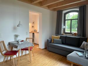 a living room with a couch and a table at Appartment Schafstall - am Unstrutradweg in Wundersleben +31 photos