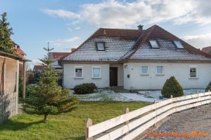 a white house with a fence in front of it at Helene in Hüttenrode