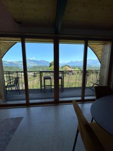 a room with a large window with a view of the mountains at Bergpanorama, nahe Interlaken 10min Thuner See in Reutigen