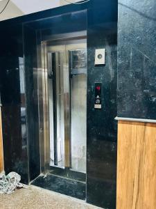 an elevator in a building with a mirror on the wall at Laxmi Inn Guest House in New Delhi
