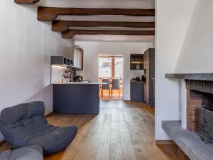 a kitchen and a living room with a fireplace at Design alpino in centro con balcone e parcheggio in Tarvisio