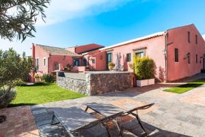 a patio with two chairs and a house at Micanera House in Viagrande