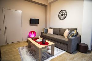 a living room with a couch and a table at Mary's cozy apartments in Pýrgos