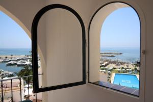 an arched window with a view of a pool at Seaside Golf haven in Cabopino Marbella in Marbella