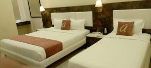 Ένα ή περισσότερα κρεβάτια σε δωμάτιο στο Astra Hotels and Suites - Sector 7 HSR Layout