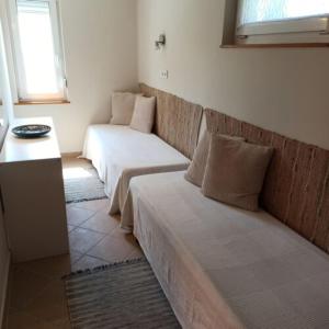 a living room with two beds and a couch at Kati Appartmann in Balatonberény