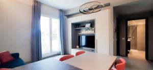 a dining room with a table and red chairs at Luxury Basilica View 19 - free private parking in Genoa
