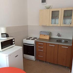a small kitchen with a stove and a sink at Kati Appartmann in Balatonberény