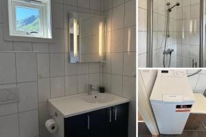 a bathroom with a sink and a toilet and a window at Ballstad Tide House - Lofoten in Ballstad +33 photos