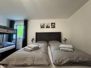 a bedroom with two beds with pillows on them at Familienapartment Buehlertal bei Buehl Baden Baden und Schwarzwald in Bühlertal