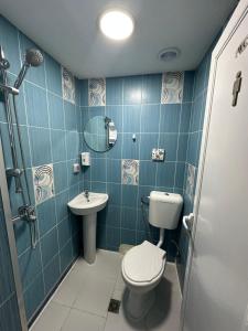 a bathroom with a toilet and a sink at Guest Rooms Comfort 2 City Center in Plovdiv