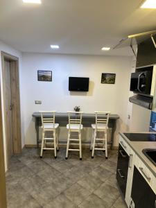 a kitchen with a table and four stools at Guest Rooms Comfort 2 City Center in Plovdiv