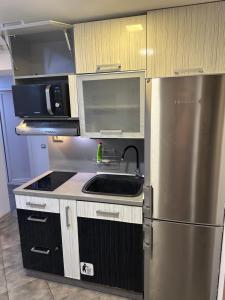 a kitchen with a stainless steel refrigerator and a sink at Guest Rooms Comfort 2 City Center in Plovdiv +11 photos
