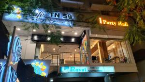 a building with neon signs on the side of it at Royal Service apartment - KK Nagar Madurai in Madurai