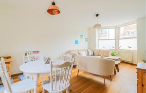 a living room with a table and a couch at Belle Villa Proche Plage in Bray-Dunes
