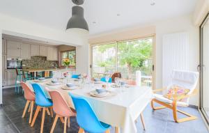 a dining room with a white table and chairs at Belle Villa Proche Plage in Bray-Dunes
