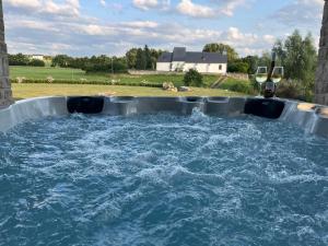 a large tub filled with water in a yard at Eifelfinca in Wiesbaum