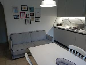 a living room with a couch and a table at Holiday in Pietra Ligure in Pietra Ligure