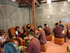 a group of people sitting in chairs in a room at Green Bamboo Lodge Resort in Cat Tien