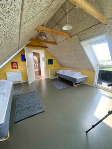 a large room with a bed and a window at Spacious Holiday Home With Views Over Limfjorden in Jørsby
