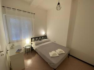 a bedroom with a bed with two towels on it at Domus Gianni in Assemini
