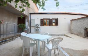 a white table and chairs in front of a house at Gorgeous Home In Casalvelino With Wifi in Casal Velino +10 photos