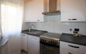 a kitchen with a sink and a stove top oven at 2 Bedroom Cozy Apartment In Montoggio in Montoggio