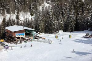 a group of people skiing down a snow covered slope at Kartala Ski Resort in Blagoevgrad