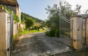 an entrance to a driveway with an iron gate at 4 Bedroom Cozy Home In Ragusa in Ragusa +22 photos