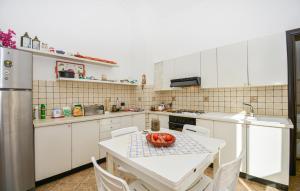 a kitchen with a table with a bowl of fruit on it at 4 Bedroom Cozy Home In Ragusa in Ragusa
