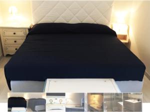 a bedroom with a bed with a black bedspread at Ai Binari in Giulianova